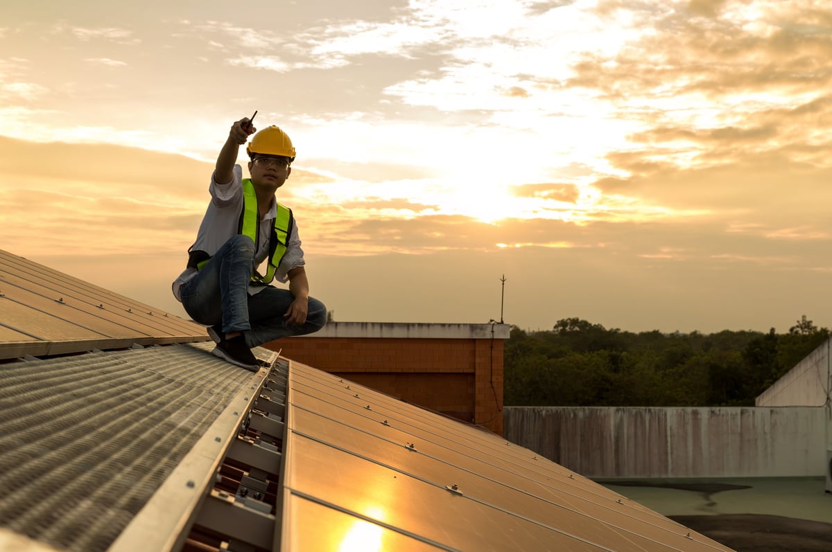 Engineer service check installation solar cell on the roof of factory