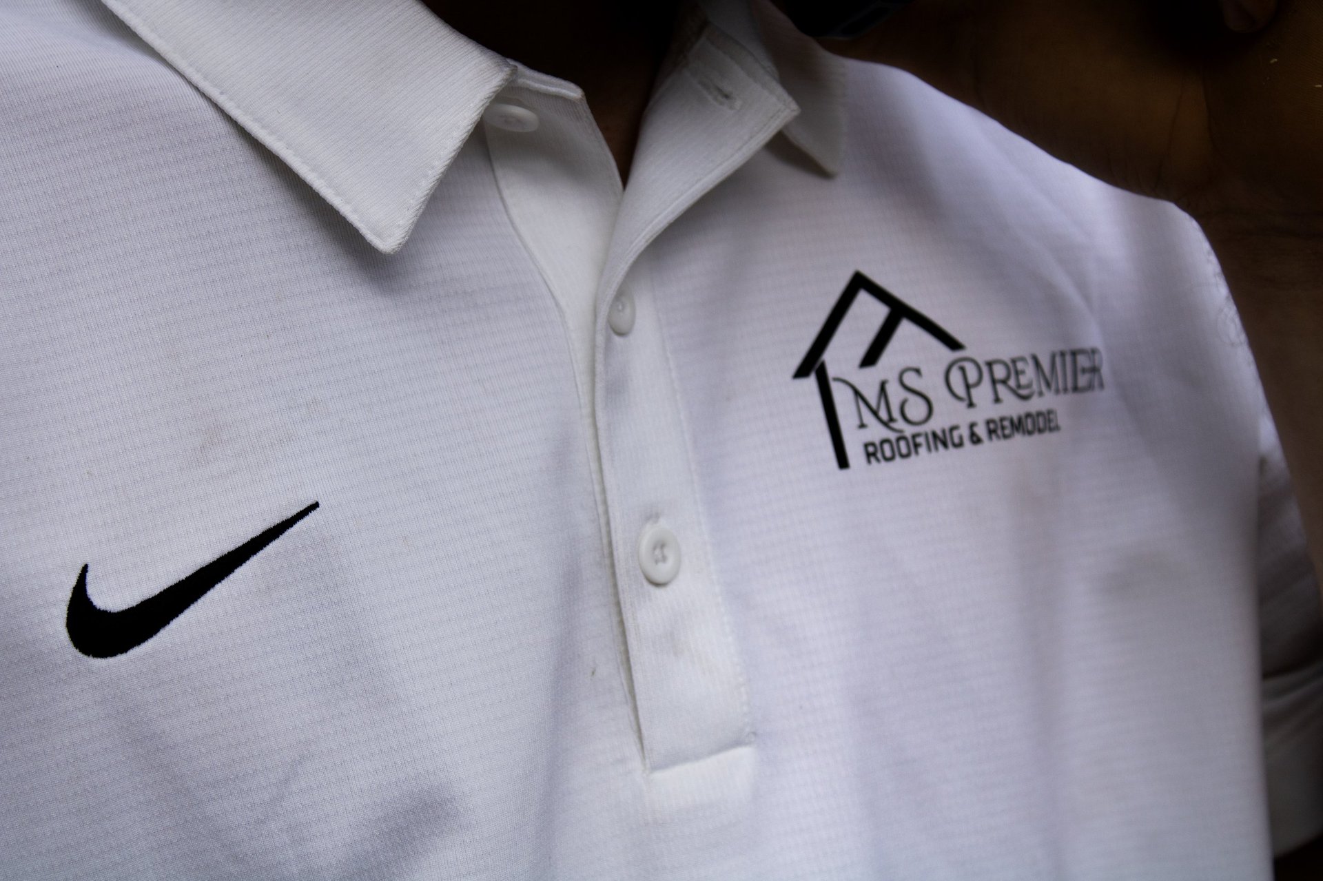 White polo shirt with Nike logo on left chest and M&S Premier Roofing & Repairs logo on right chest